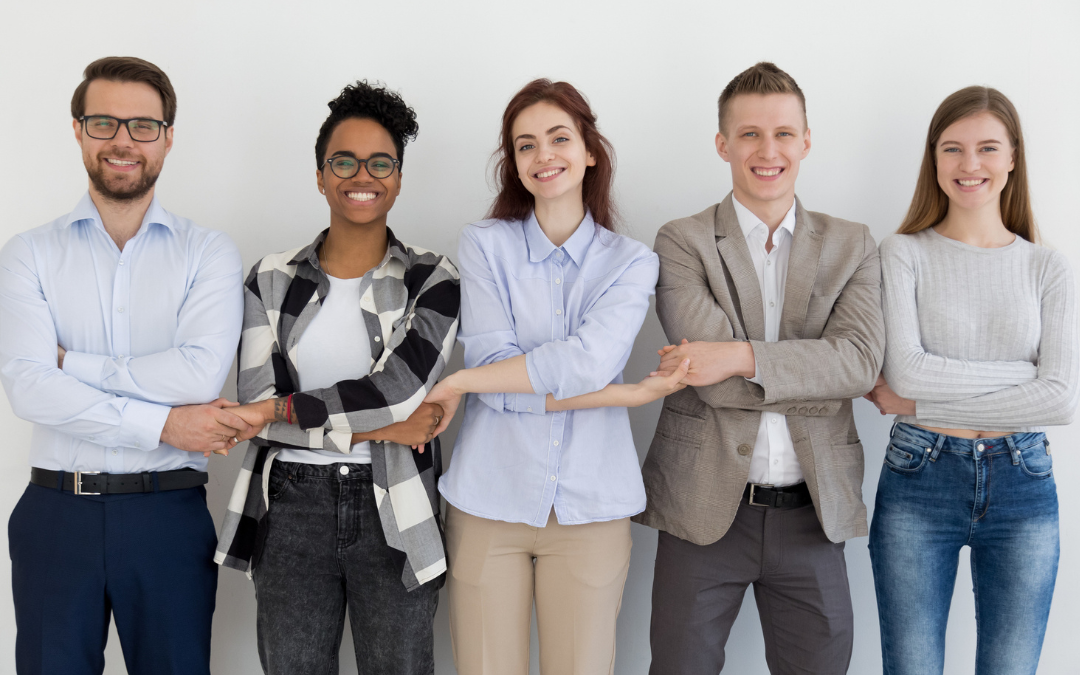Is Wellbeing One of Your Key Priorities for 2026/27? Five diverse individuals standing together with arms crossed, smiling at the camera.